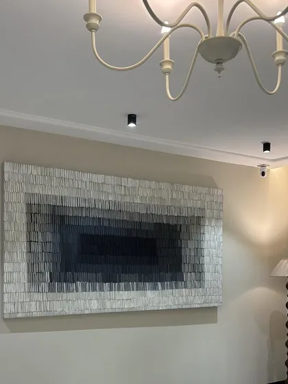 I love seeing my art transform a room. This 8-foot by 4-foot textured canvas, installed in a beautiful Gujarat residence, uses a gradient of grays to create depth and a sense of calm sophistication. It's a great example of how large-scale minimalist art can make a powerful statement.