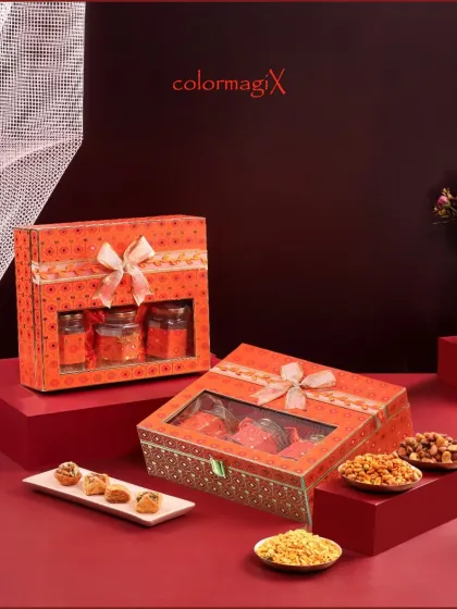 Our vibrant orange bandhani print boxes bring a traditional touch to Diwali gifting. Available in two styles, these hampers are filled with sweets and snacks, perfect for celebrating the festival's joy.