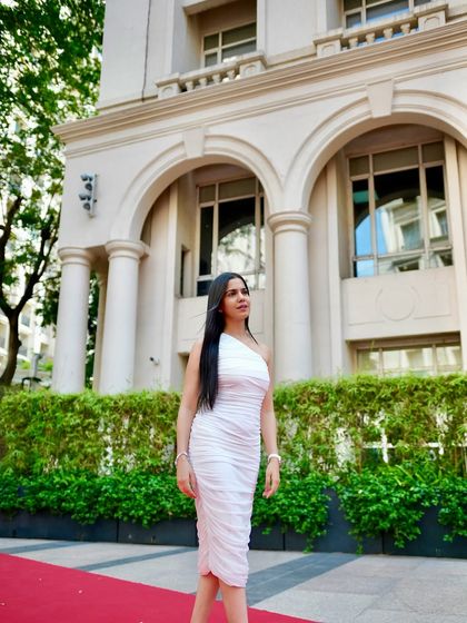 Walking the red carpet in a chic, one-shoulder white dress. This look is all about confidence and modern elegance.