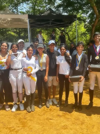 My team celebrating their medal wins at the Auroville Horse Show. These shared moments of success build a strong and supportive community.
