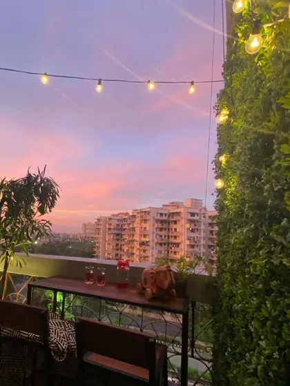 Even a small balcony can become your favorite breakaway spot. We installed a simple bar table, a vertical green wall, and festive string lights to make this space feel cozy and perfect for enjoying a beautiful evening sky.