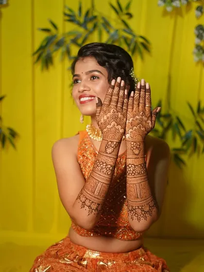 A joyful shot of a bride with her finished mehndi. My goal is to create art that you love and that makes you feel beautiful on your wedding day.
