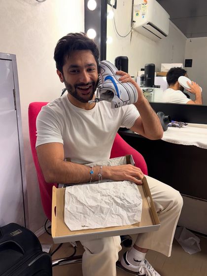 Creator Harsh Beniwal unboxing and reacting with a huge smile to his custom cartoon-style Nike sneakers.