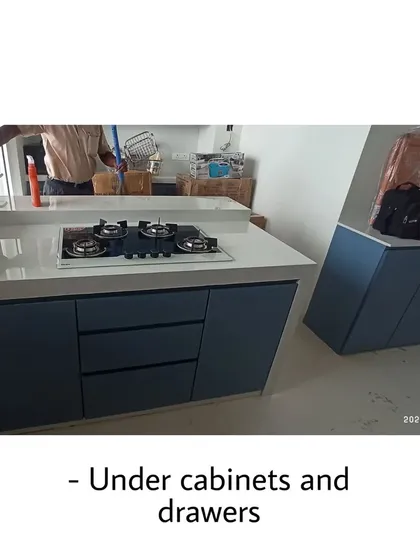 This image shows the under-counter cabinets and drawers of the blue kitchen. The handleless design contributes to its minimalist and modern appeal.