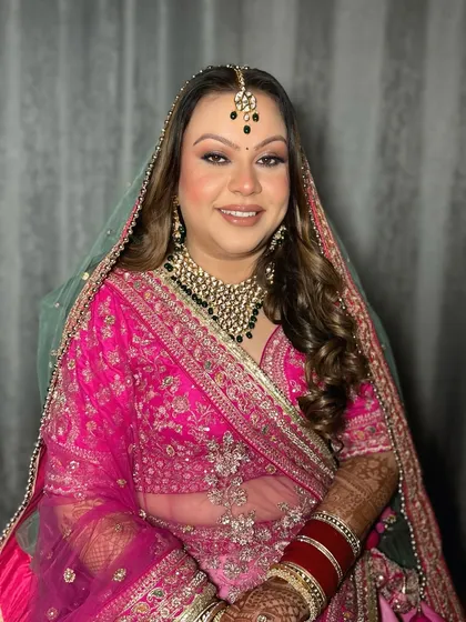 A gorgeous bride ready for her wedding day in a vibrant pink lehenga. I created a soft glam look with a defined eye to complement her outfit and jewelry.
