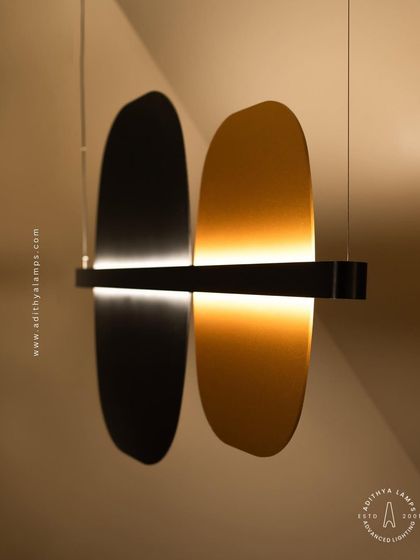A study in balance and contrast, this fixture features opposing black and gold panels bisected by a line of light. This piece embodies the principle of yin and yang, offering a minimalist yet deeply symbolic lighting solution.