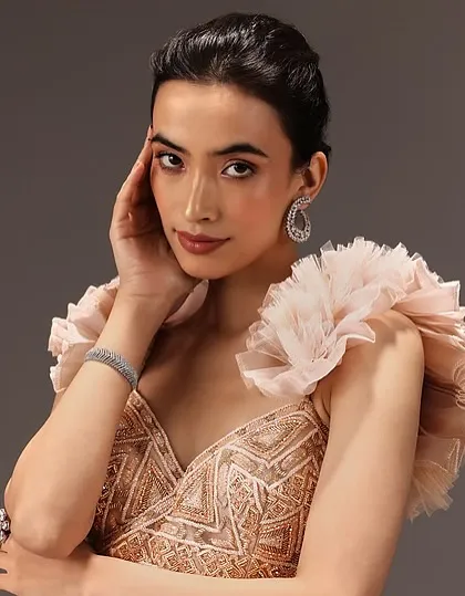 A classic soft glam look for an occasion wear brand. The makeup is warm and neutral, and the hair is styled in a neat updo, creating a timeless and elegant feel.