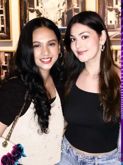 Two friends smiling for the camera at a private party. Our flattering lighting ensures everyone looks their best, no matter the venue's ambiance.