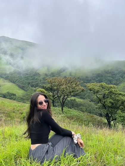 A candid shot of a traveler enjoying the view at Netravathi peak.