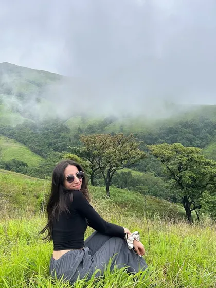 A candid shot of a traveler enjoying the view at Netravathi peak.