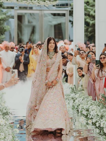 Another shot of Tanisha's stunning bridal entry, with guests capturing the beautiful moment.