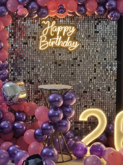 A detailed shot of the cake table area in front of the sequin wall for the 26th birthday party.