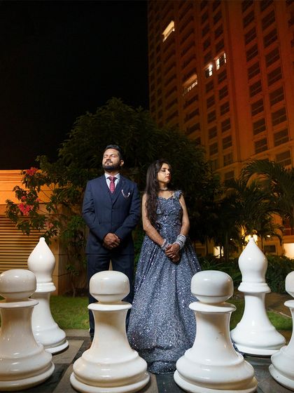 A stylish and powerful portrait of the couple standing among giant chess pieces. This is a unique and memorable shot that adds an editorial feel to their album.