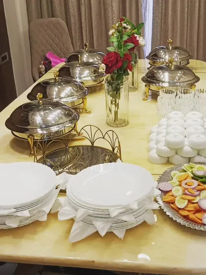 An intimate family lunch setup on a dining table. Even with limited space, my team can arrange a beautiful and functional buffet with a full salad bar and premium chafing dishes.