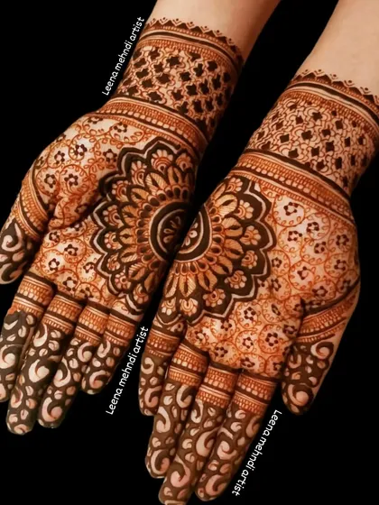 The beauty of a mandala lies in its perfect symmetry. This intricate design features a central floral mandala that expands outwards, with detailed patterns on the fingers and a complementary cuff design.