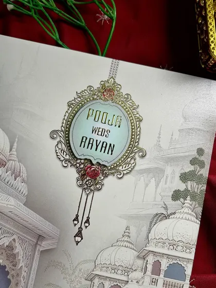 A detailed shot of the hanging mirror-style nameplate, a unique and elegant feature of this invitation design.