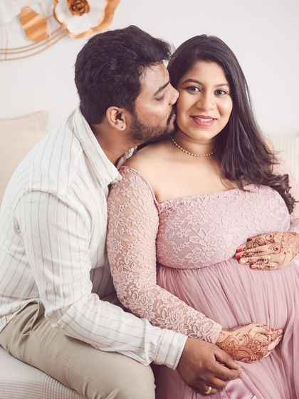 A sweet kiss for the glowing mom-to-be. We love capturing these close-up, affectionate moments that show the couple's excitement and love.