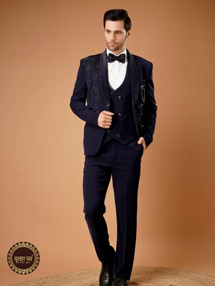 For a reception or cocktail evening, nothing compares to a perfectly tailored tuxedo. This deep navy three-piece suit features an embellished lapel, blending classic western tailoring with a touch of Indian grandeur.