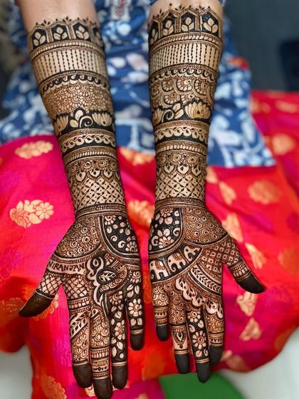 A beautiful design featuring elephant and paisley motifs on the palms, with traditional bands of patterns on the arms.