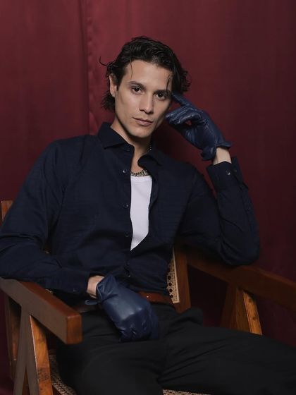 A solo shot from the Cairon campaign, where I styled the model in a dark shirt, trousers, and leather gloves for a moody, cinematic feel.