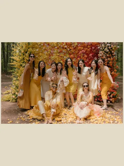 Surrounded by their sunshine squad. I always recommend a color theme for guests at events like the haldi. Here, the coordinated yellow and white outfits create a visually stunning and cohesive group photo.