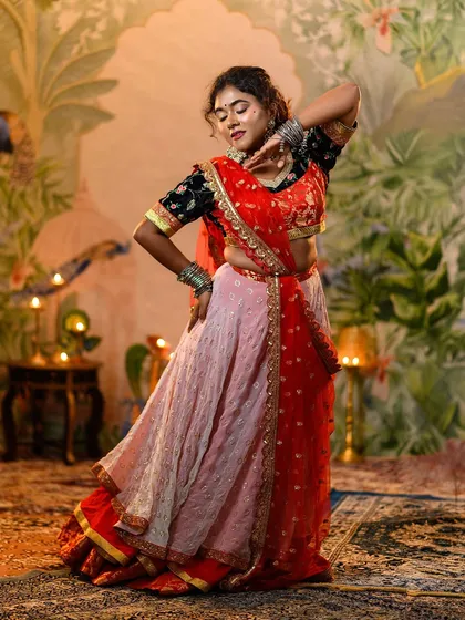Feel the energy of Bollywood with our vibrant 'Ram Leela' inspired lehenga. The flowing skirt and intricately designed choli are perfect for a sangeet performance or a festive Navratri celebration.