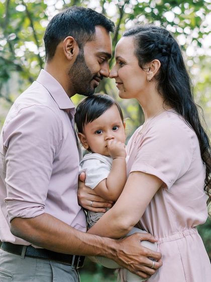 A tender family portrait in a beautiful garden. The soft light and close embrace create a feeling of warmth and love.