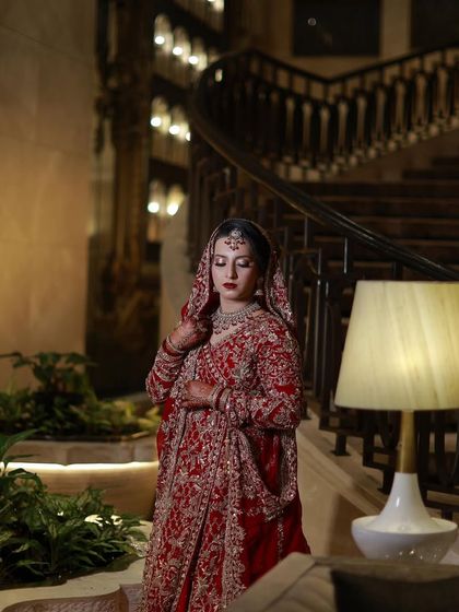 Another shot of the bride on the staircase, capturing the regal feel of her complete bridal look.