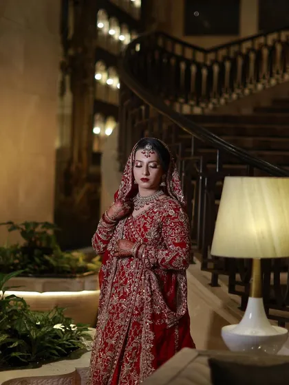 Another shot of the bride on the staircase, capturing the regal feel of her complete bridal look.