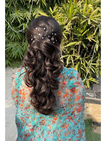 The back view of the ponytail, with pearls scattered like stars.