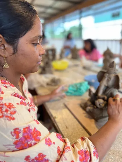 A participant in our Ganesha workshop carefully works on the fine details of her sculpture.