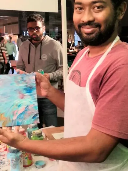 It’s not just for kids. I create a relaxed space where adults can also reconnect with their creative side. This gentleman was so proud of the abstract piece he made at one of my fluid art pop-ups.