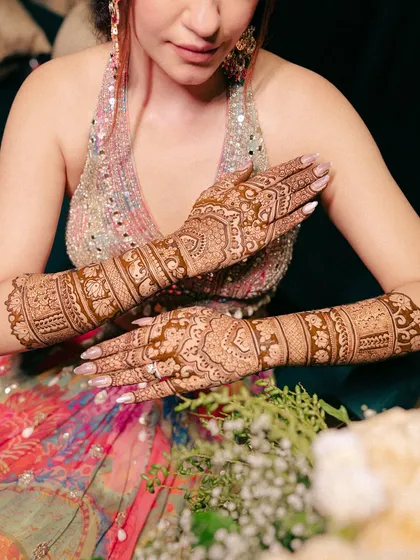 A detailed shot of the bride's intricate Mehendi design, showcasing the beautiful artistry that is such an important part of the wedding celebrations.