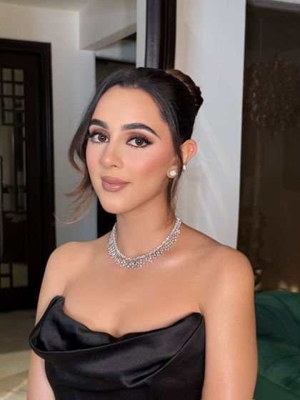 A closer look at the makeup, showing the clean lines of the eyeliner and the subtle contouring that defines her features beautifully.