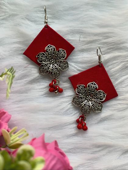 Another beautiful fabric earring design in red, this time with a larger oxidised silver flower charm and tiny red bead drops.