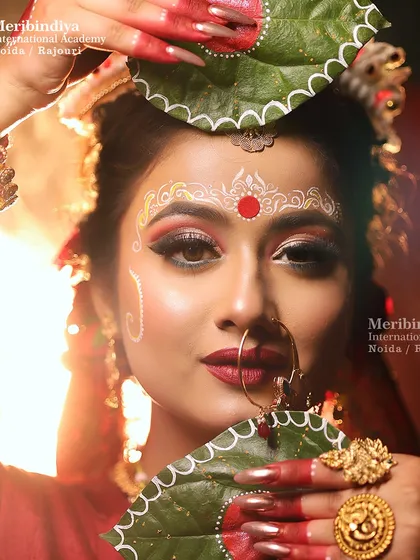 This image captures the essence of a Bengali bride, a look our students learn to perfect, complete with traditional accessories and makeup techniques.