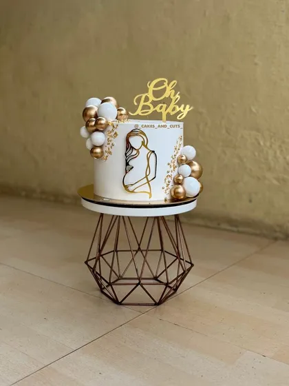 A clean shot of our popular white and gold "Oh Baby" cake. This order came all the way from the US for a delivery in Thane.