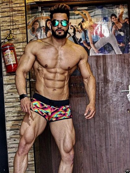A confident pose showing off a shredded physique. The combination of size, definition, and a confident attitude is what makes a fitness model stand out.