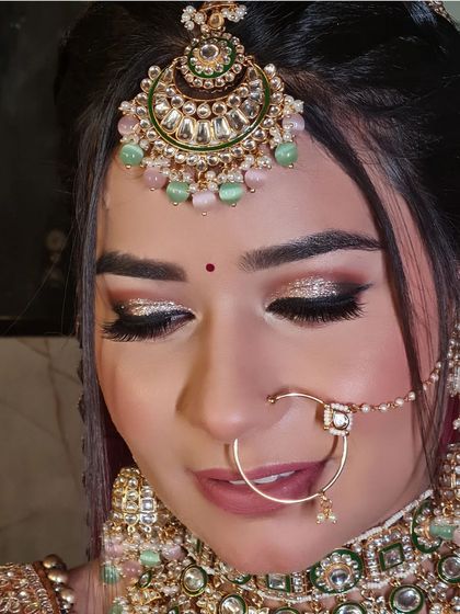 Prettiest. A close-up of this bride's stunning glittery eye makeup and beautiful pastel jewelry.