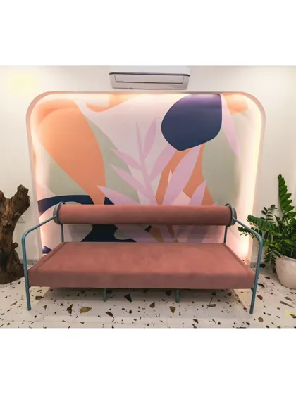A cozy waiting area in our office. The colorful abstract backdrop and modern sofa create a vibrant and welcoming spot for guests.