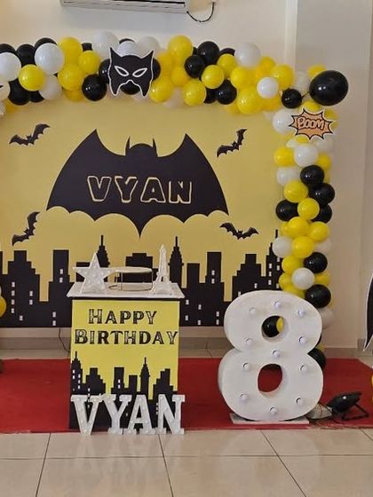 Another angle of the Batman party stage, showing the full setup with the city skyline backdrop and character cutouts.