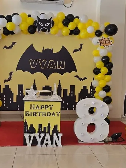 Another angle of the Batman party stage, showing the full setup with the city skyline backdrop and character cutouts.