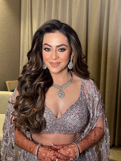 A close-up of the bride, her big, beautiful curls and smoky eye makeup creating a stunning combination.