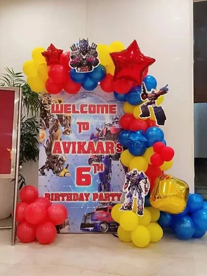 A welcome entrance for a Transformers 6th birthday party. This setup includes a themed welcome board and a balloon arrangement to greet guests as they arrive.