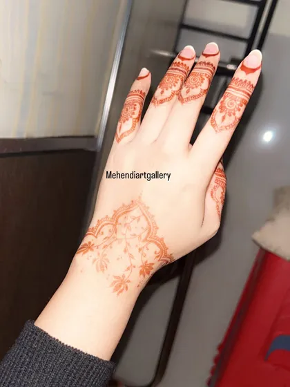 The beautiful light orange stain of the delicate floral vine design, pictured shortly after the paste has been removed. This color will deepen into a rich maroon over the next two days.