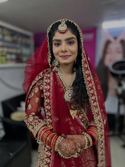 A full portrait of the bride, looking serene and beautiful in her complete Nikah attire.