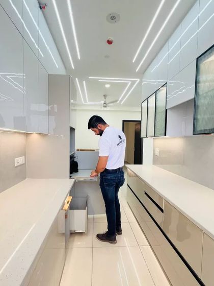 Demonstrating the functionality of a built-in dustbin drawer, a small but important feature for a clean and organized kitchen.
