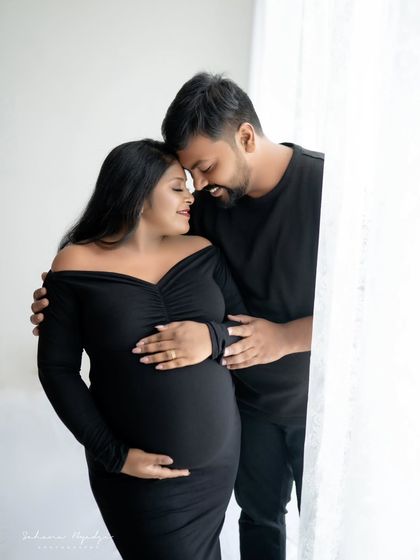 A sweet and intimate moment for the couple, both dressed in black. The soft window light creates a gentle and romantic mood for this portrait.