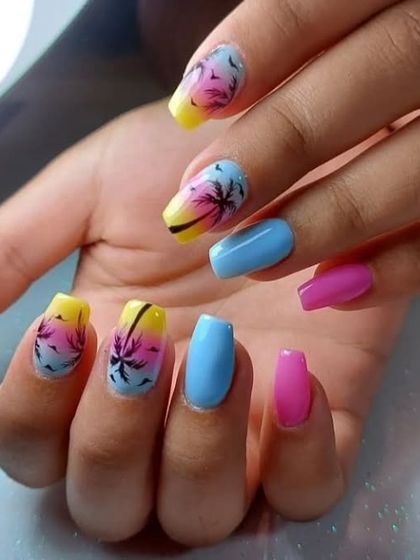 A tropical-themed manicure with a sunset ombre and palm tree silhouettes, perfect for a vacation.