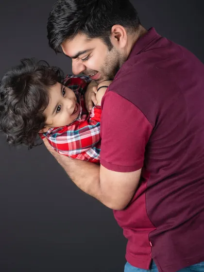The playful, loving interaction between a father and his child. These candid moments are so precious.